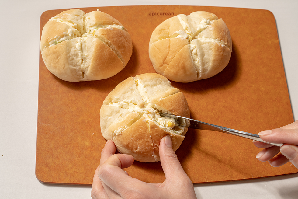 丸いパンに放射状に切り込みを入れ、コーンとそら豆を混ぜたクリームチーズを挟んでいく。